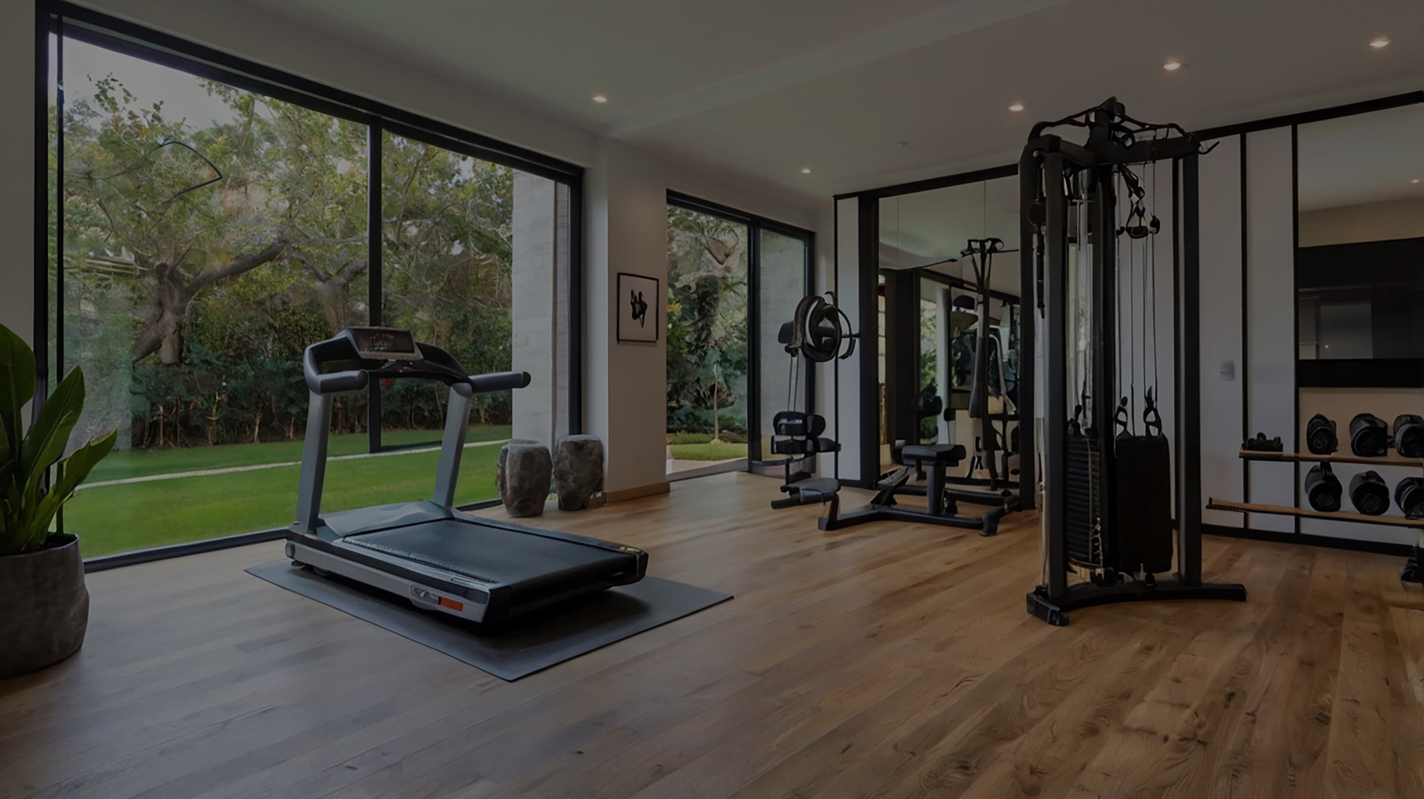 Open-plan home gym with a glass door leading to the garden